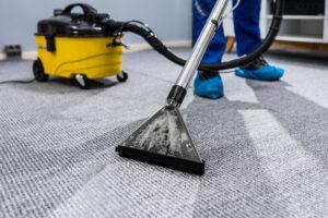 Person Reinigung Teppich mit Staubsauger