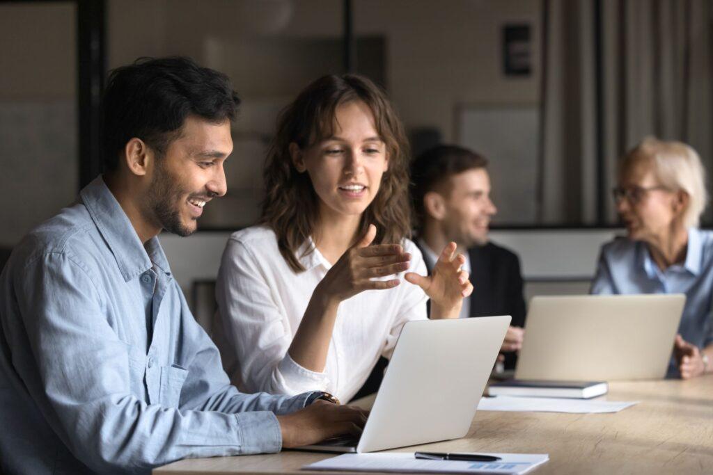 zwei personen besprechen text am laptop im buero